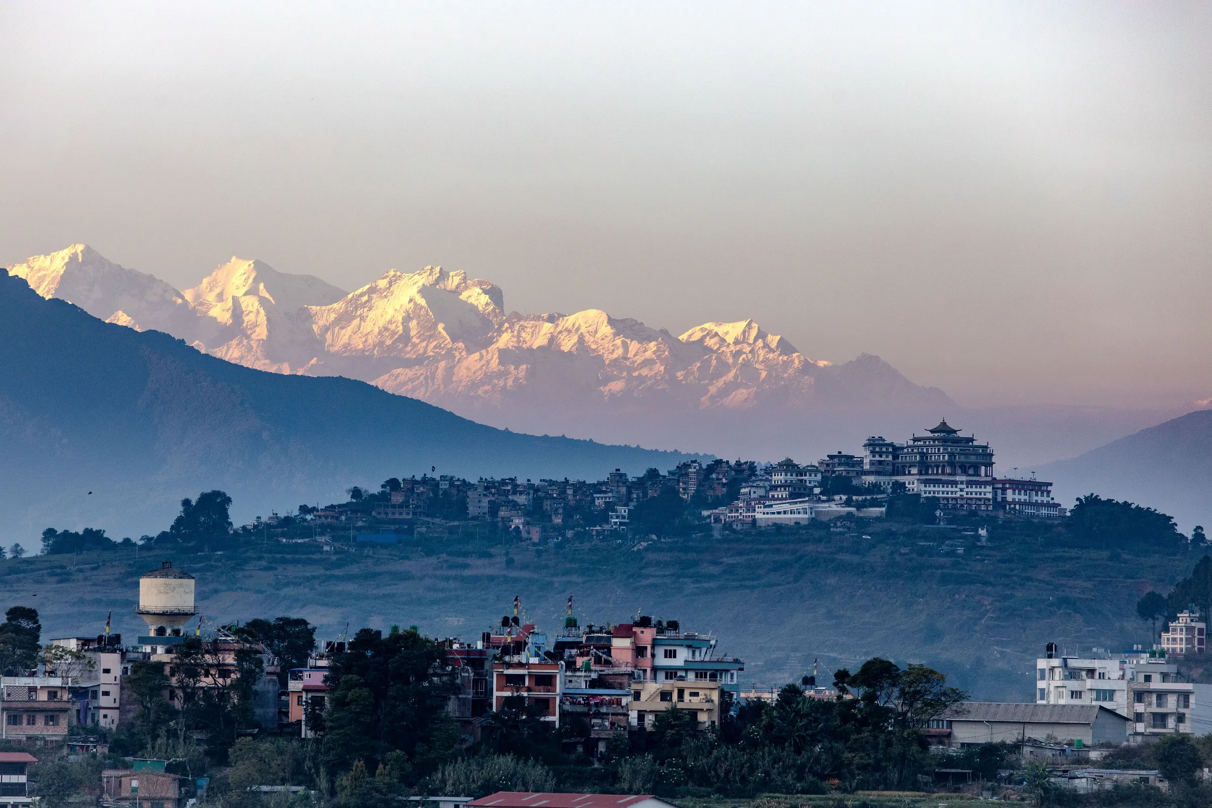 The Himalaya at sunrise above a hillside town in the Kathmandu Valley, Nepal